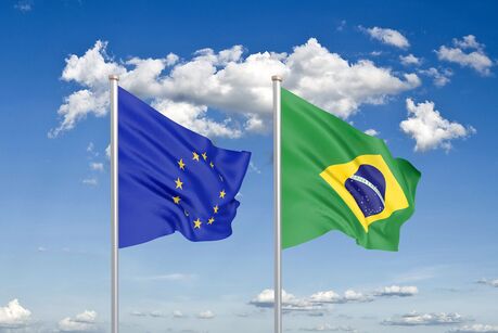Flags of the European Union and Brazil waving side by side against a blue sky, symbolizing the EU-Brazil data protection adequacy decision