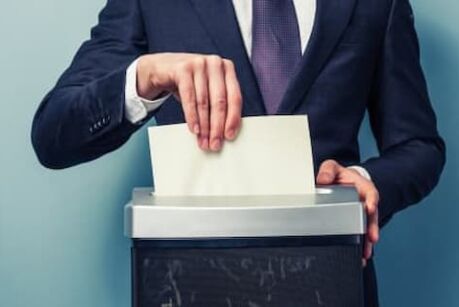 Businessman shredding documents