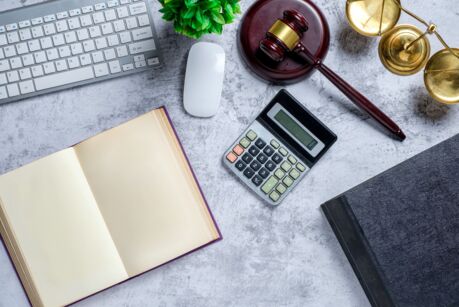 Office lawyer desk with law books,calculator,computer, Judge gavel and scales of justice. Justice and law concept. Top view