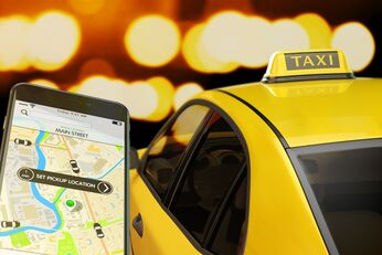transportation network, modern smartphone with app for online taxi ordering service on screen, car with taxi sign at roof on street at night