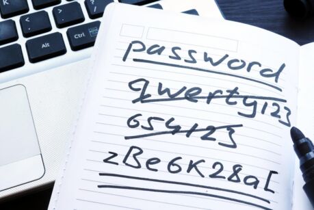 Strong and weak easy Password. Note pad and laptop.