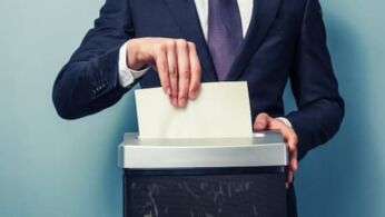 Businessman shredding documents