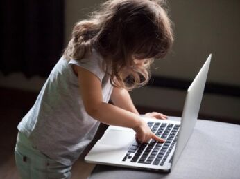 Curious smart little girl typing on laptop alone, clever cute child using computer online without permission, forbidden internet content parental protection, pc control and security for kid concept